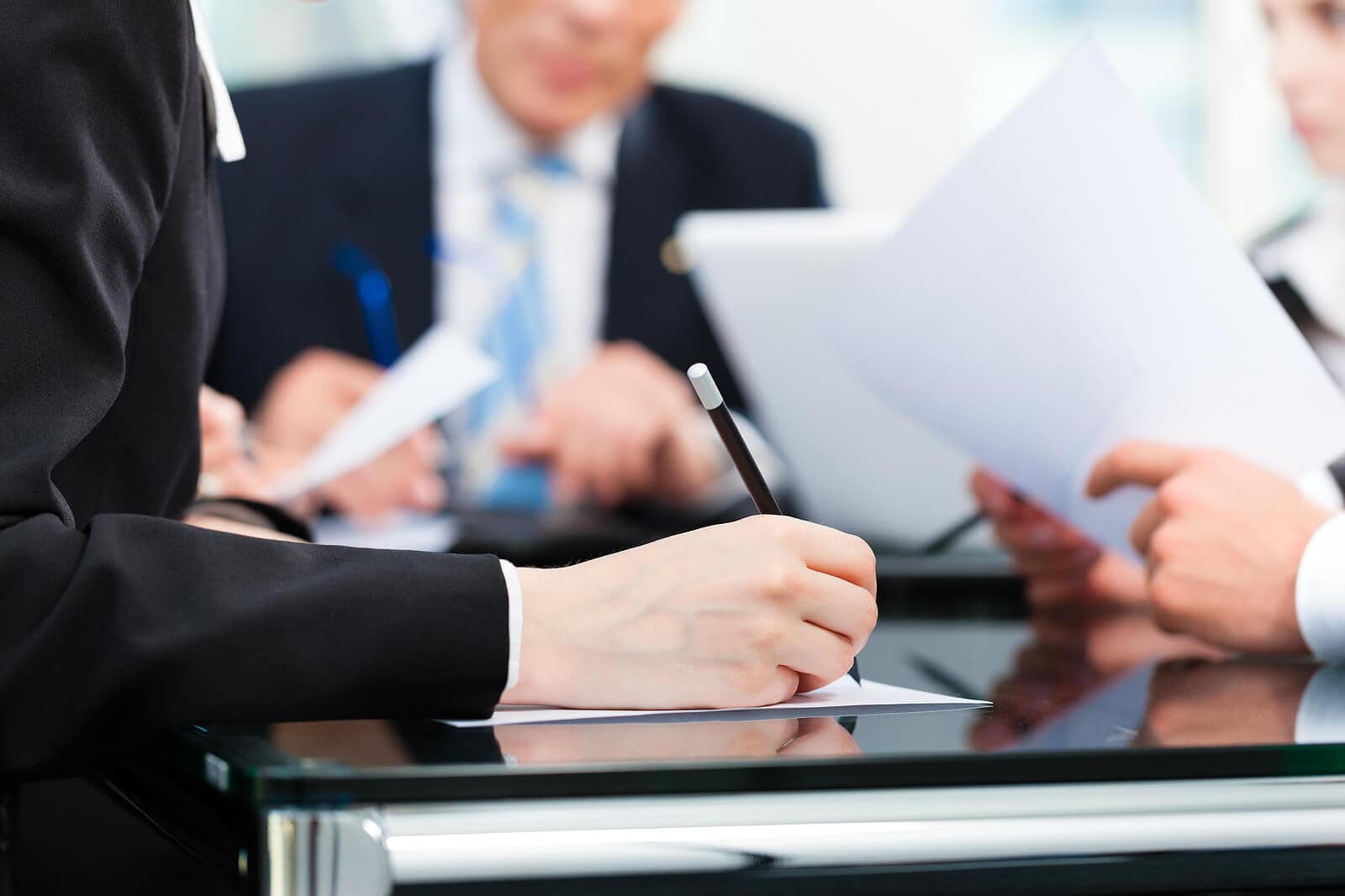 team discussing documents during meeting
